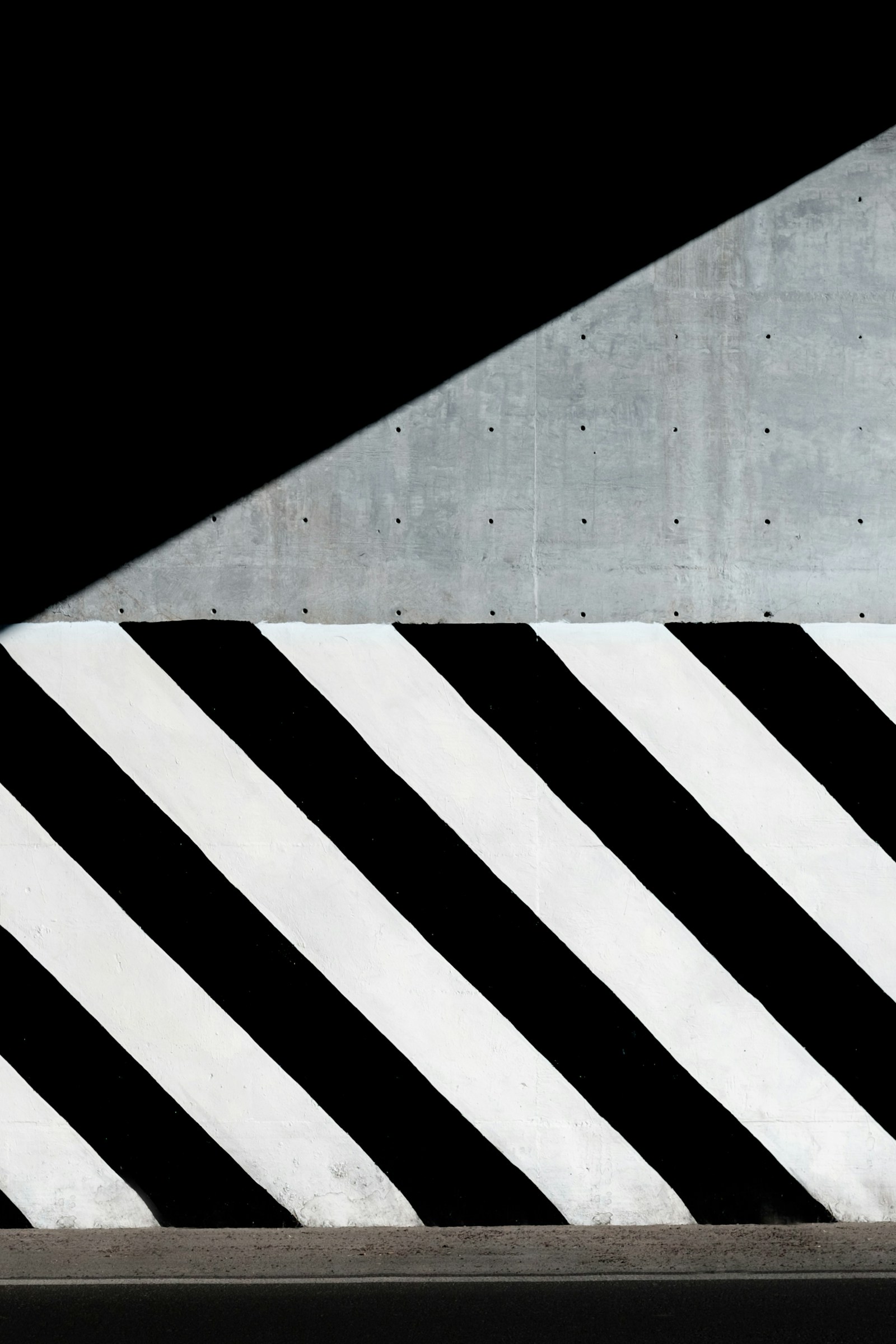 White and black diagonal striped paint on wall